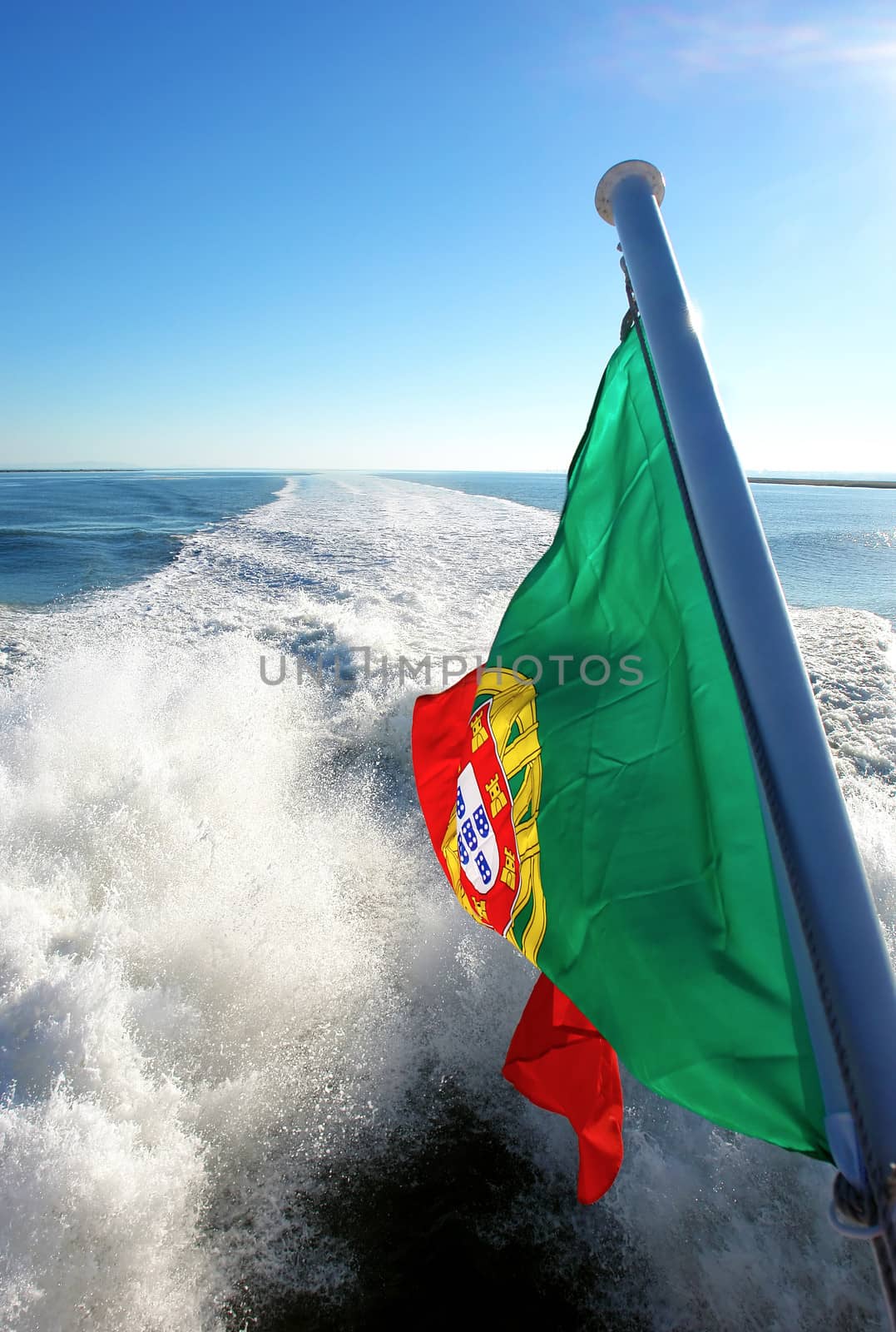 View of Lisbon's river Tagus and Portuguese flag, Portugal                           