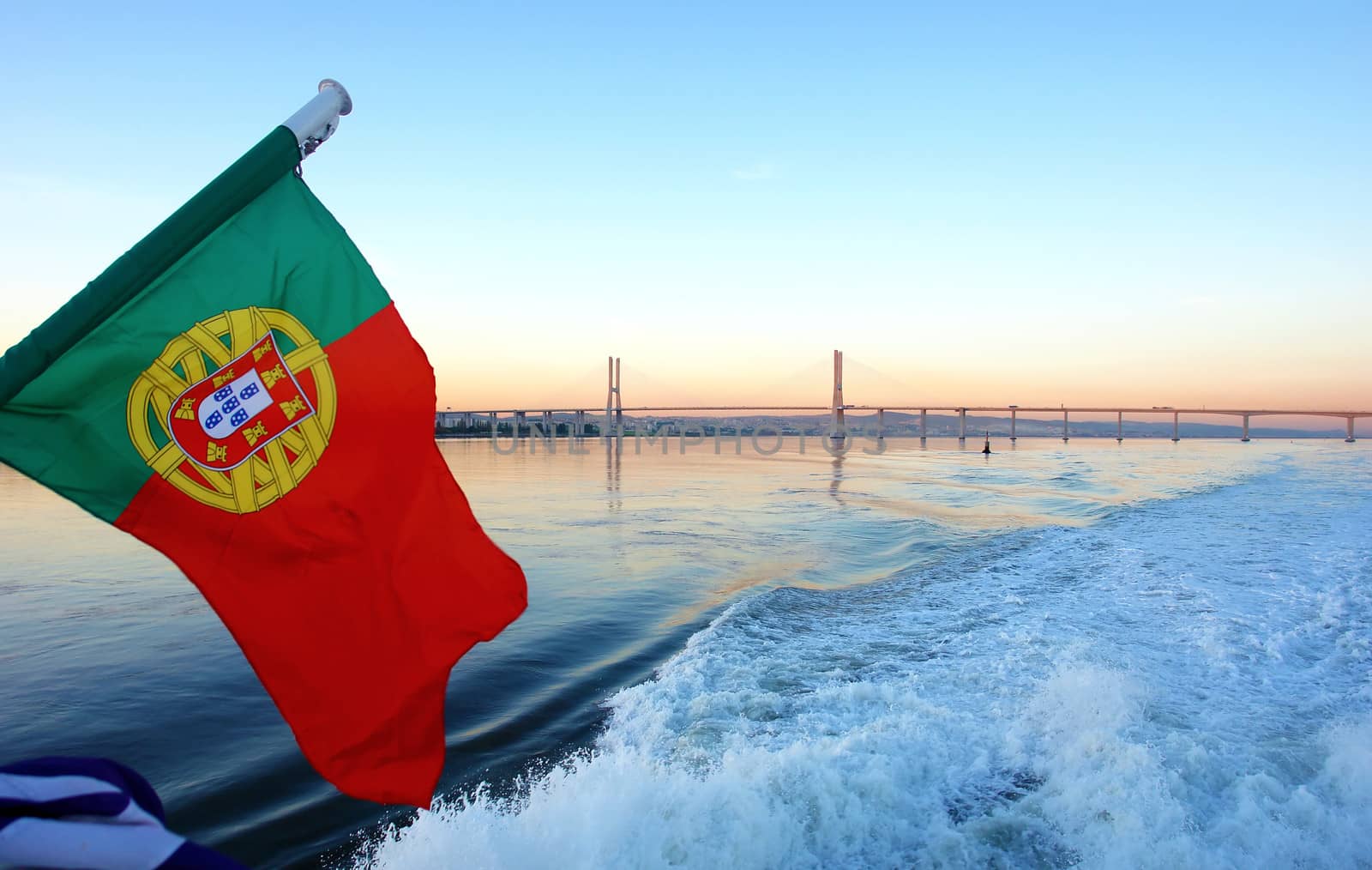 View of boat in Lisbon's Tagus river and "Vasco da Gama Bridge" in the background, Portugal