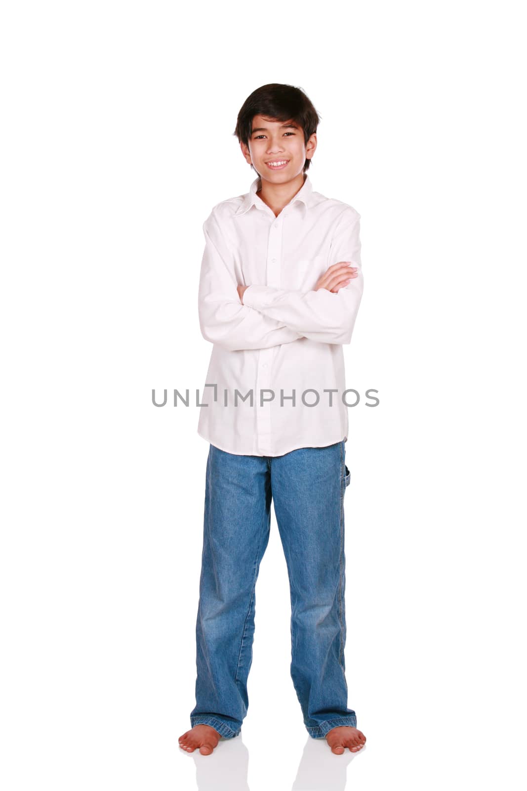 Twelve year old boy standing arms crossed,
