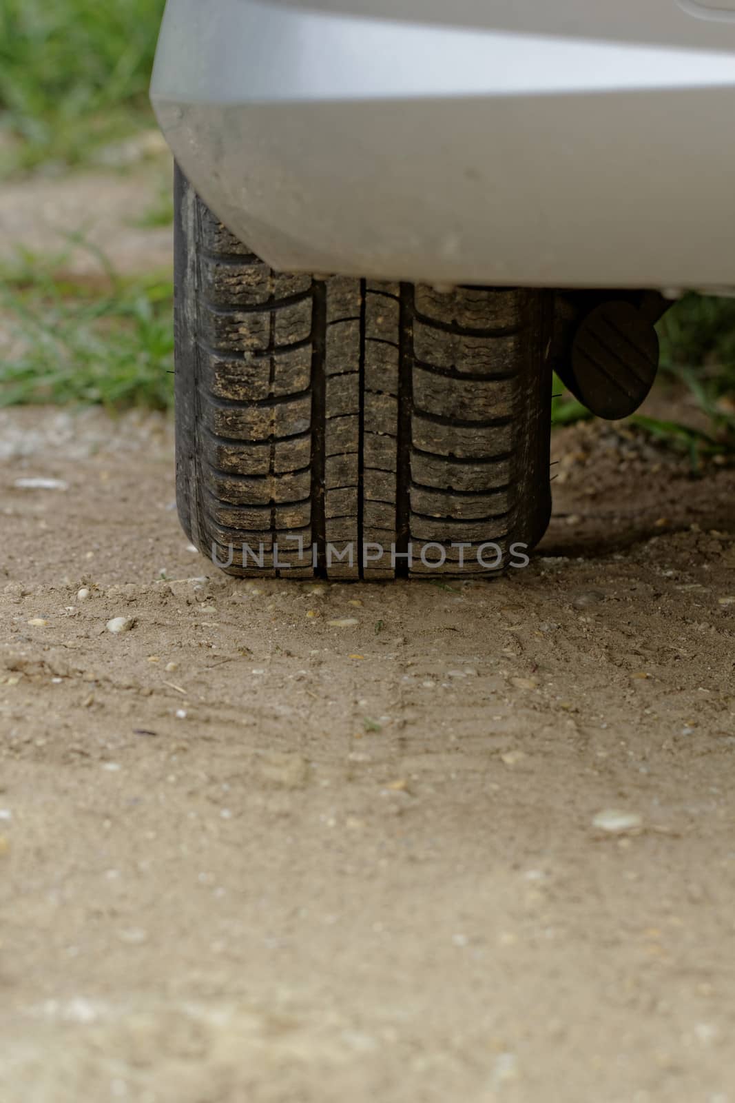 Car wheels on a dusty road detail by NagyDodo