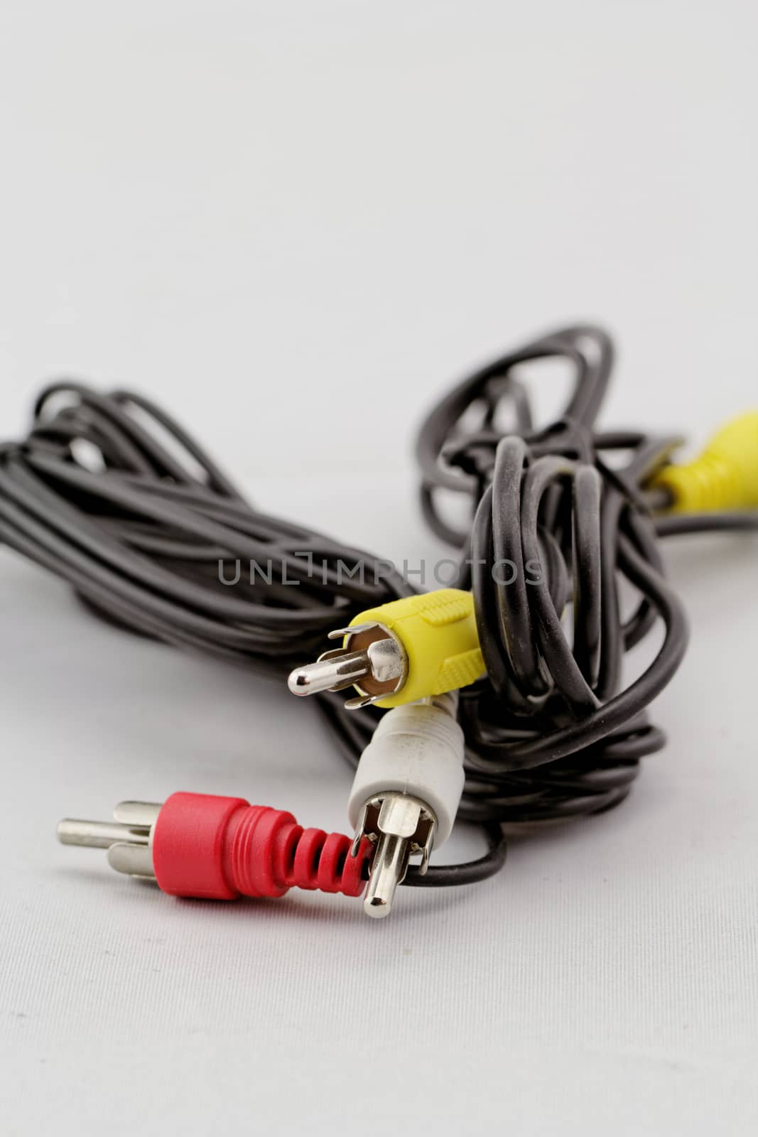 three audio (left - right) - video RCA cable and plug (red, white, yellow) on white background