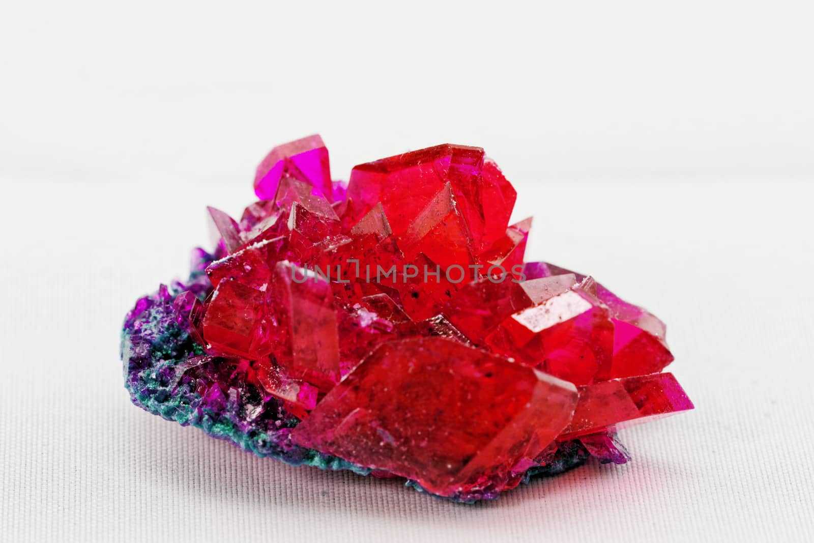 close up of crystals in ruby color on white background (red crystal)