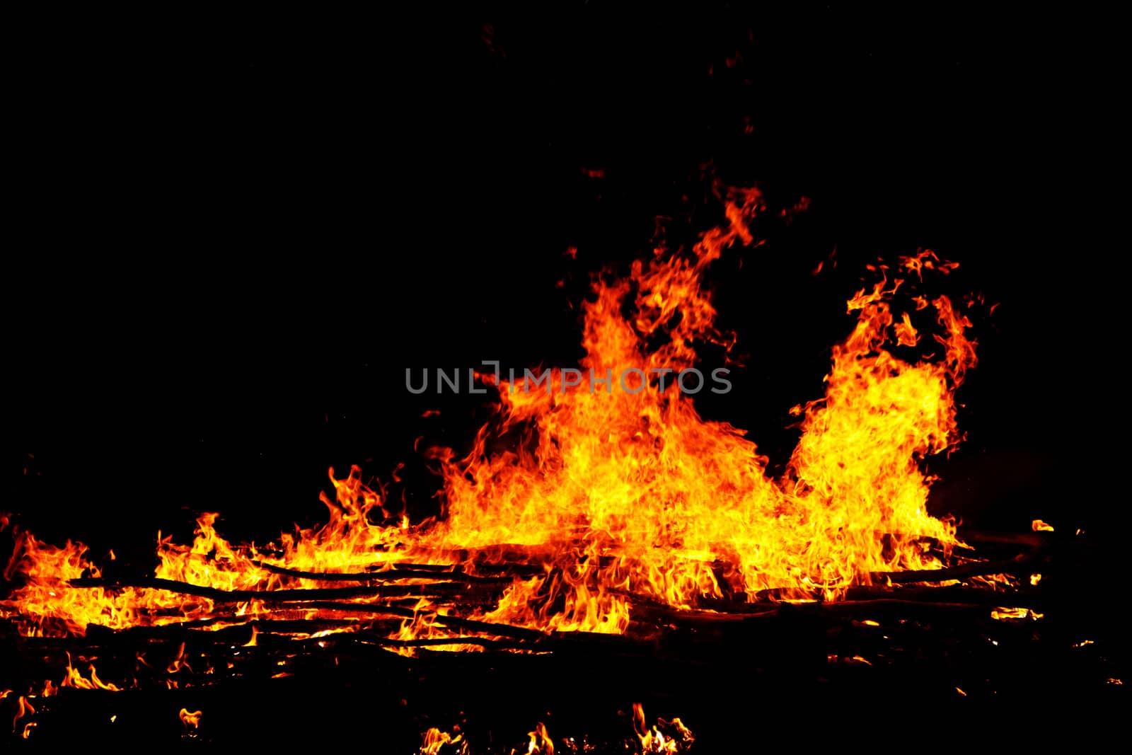 red flames of huge bonfire or campfire as black backgorund