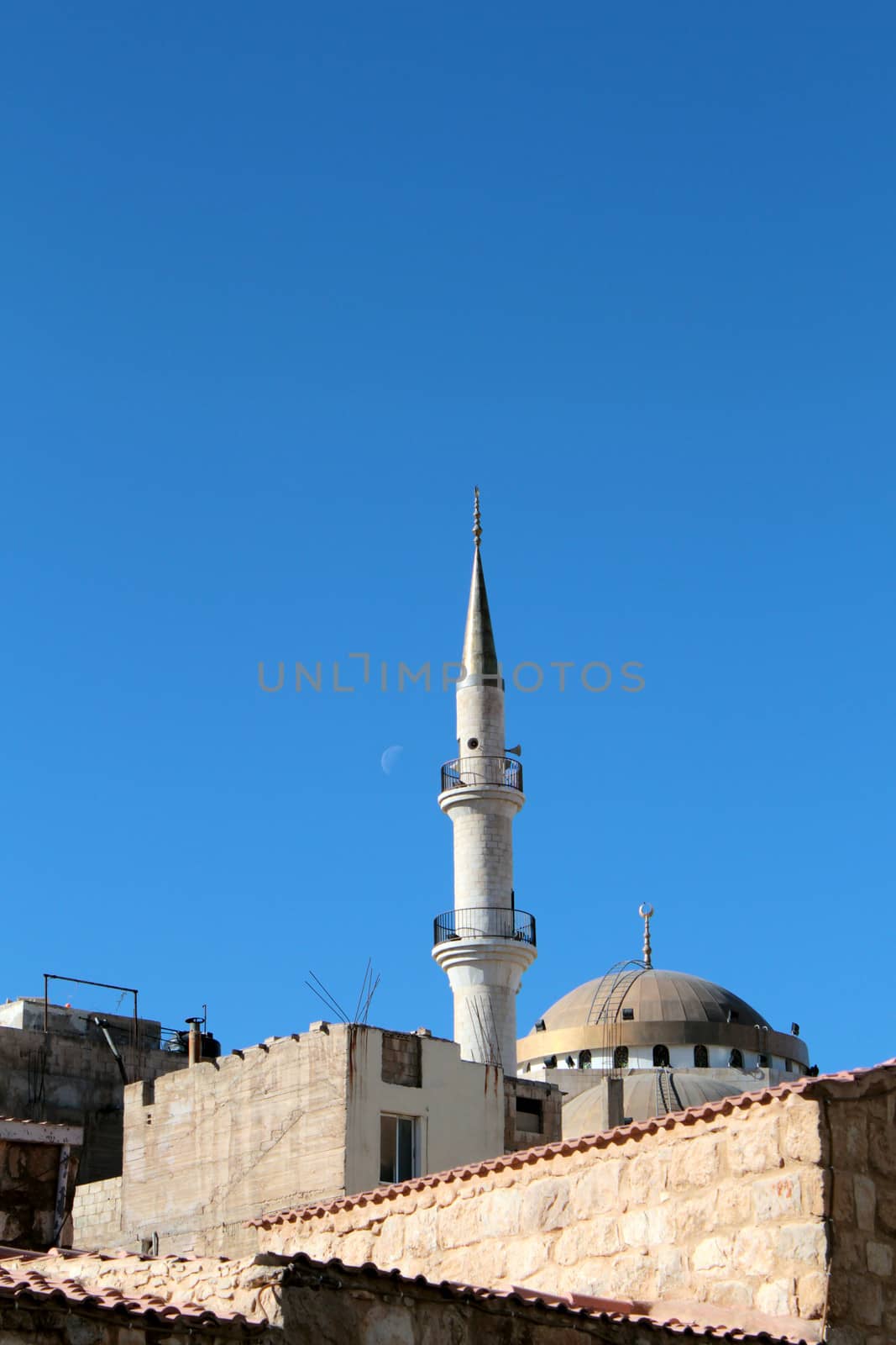 Madaba "jesuscristo" Mosque minaret in blue sky, moon in the background, Jordan