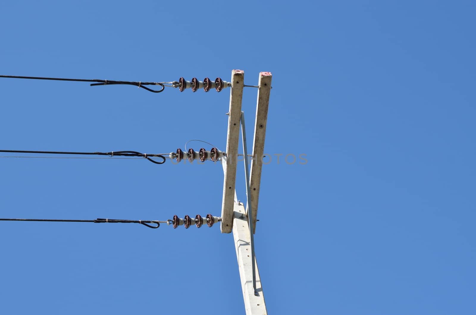electricity post with blue sky