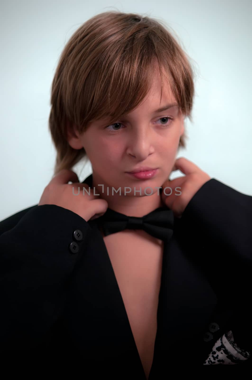 Portrait of a boy wearing  jacket and bow tie.
