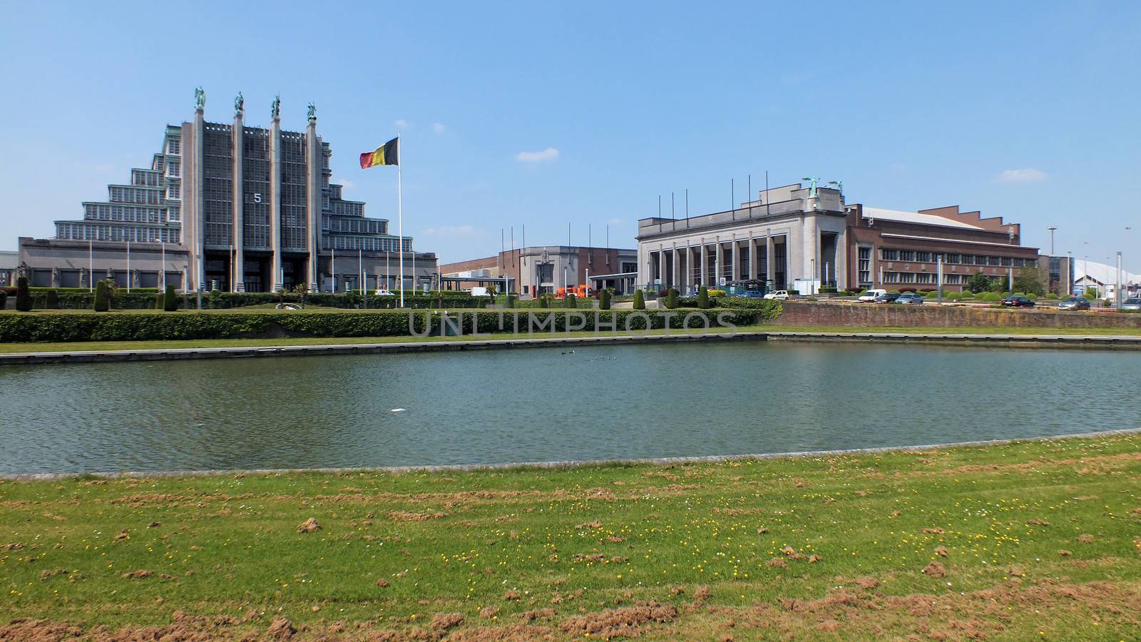 The Brussels Expo is Belgium's biggest Exhibition Centre and halls 5, 6 and 10 were built for the 1935 Brussels International Exposition.The Belgian architect Joseph Van Neck was the principal architect of the Art Deco Palais des Expositions (hall 5), with its interior concrete parabolic arches, and its four heroic bronze statues on piers.