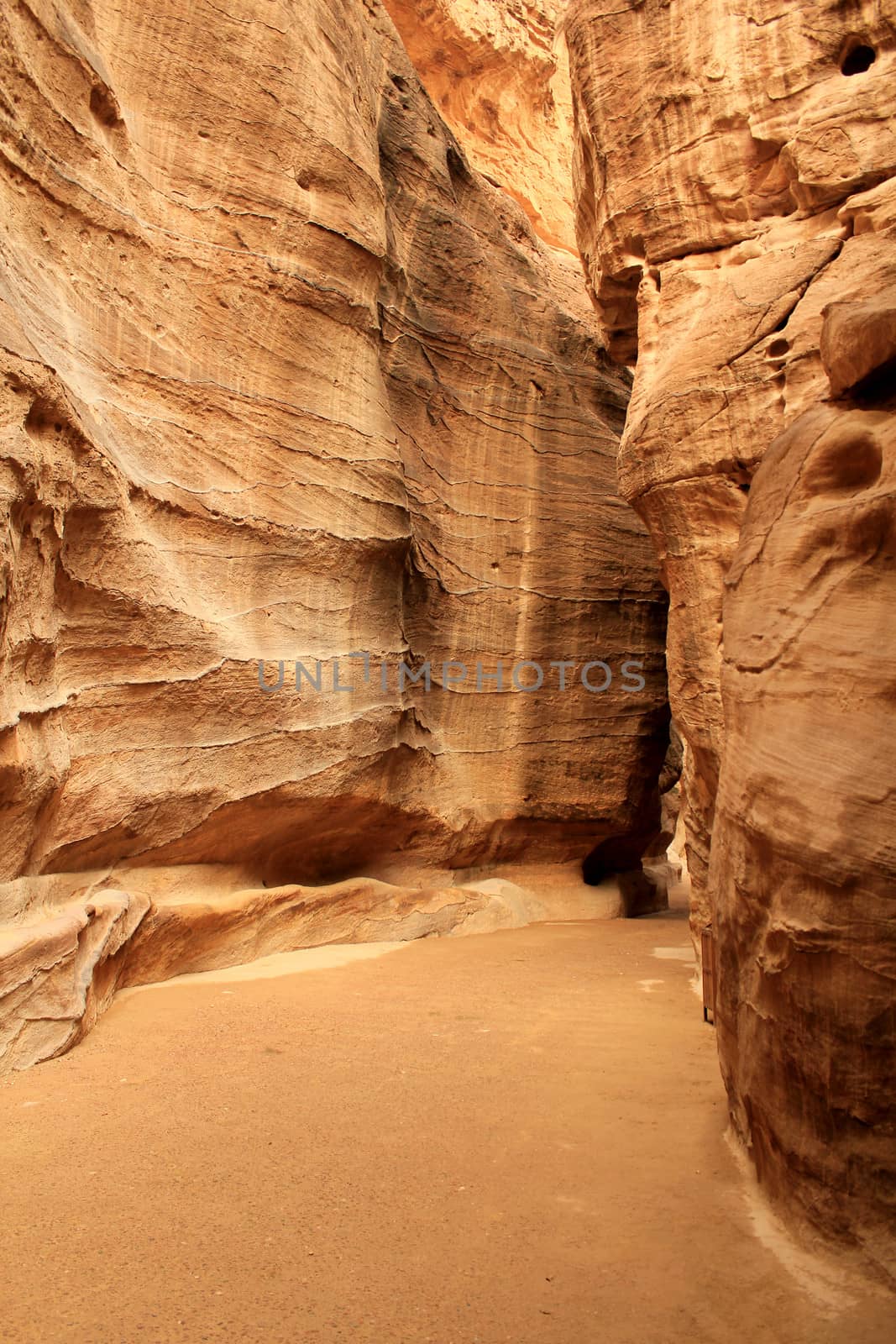 Rosy red walls of the Siq canyon, leading to the Treasury in Petra, Jordan.