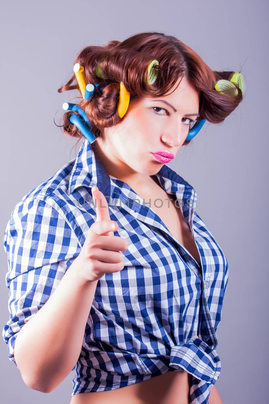 portrait of attractive pretty girl with curlers