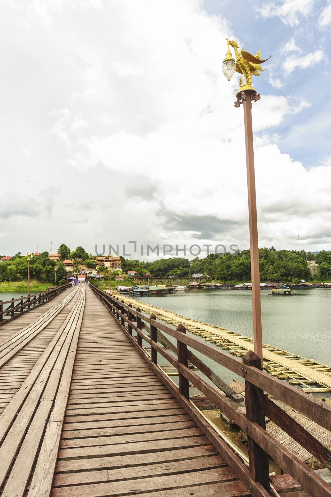 Traditional long wooden Mon Bridge in Songkhla Buri, Thailand.  by ngungfoto