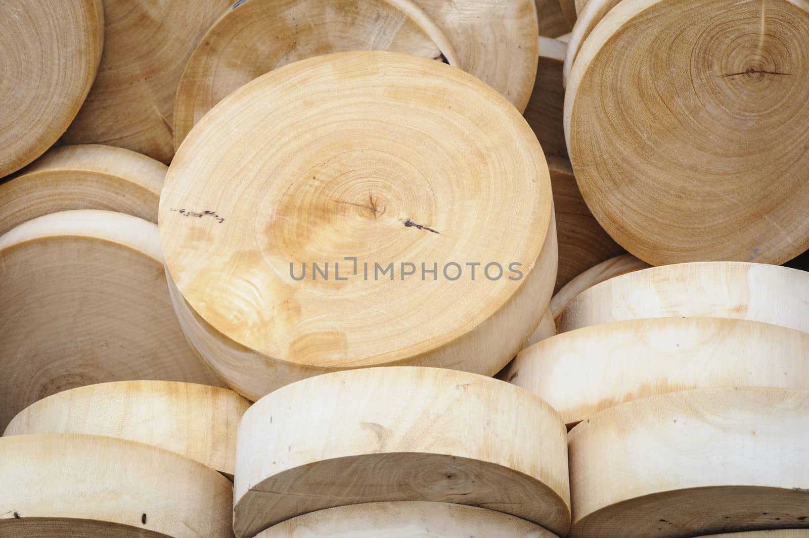 Round wooden cutting boards in market, Thailand.