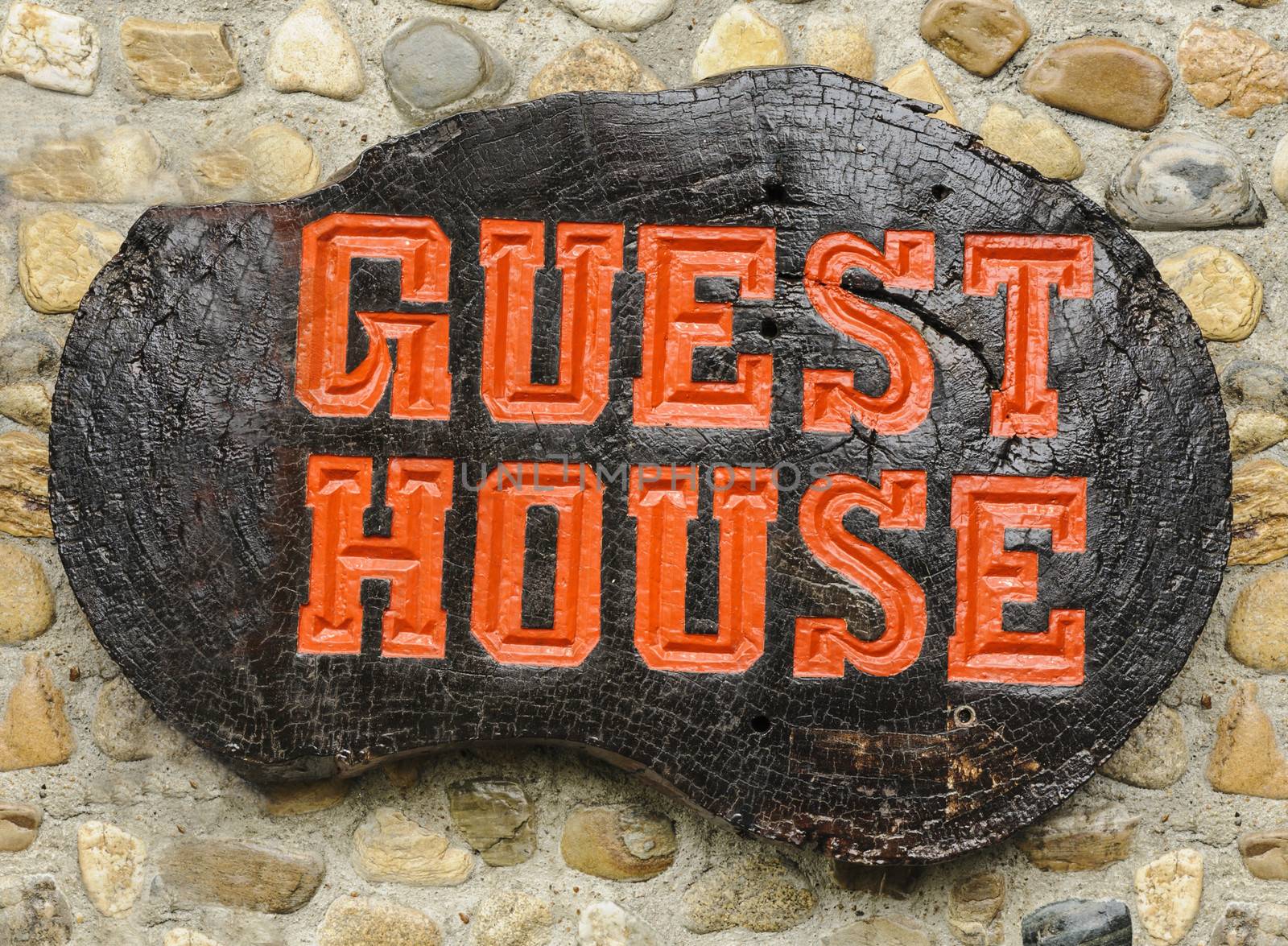 Old retro wood sign with the text Guest house in Thailand.