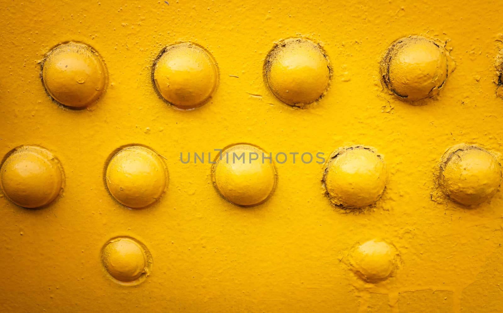 yellow metal background with rivets