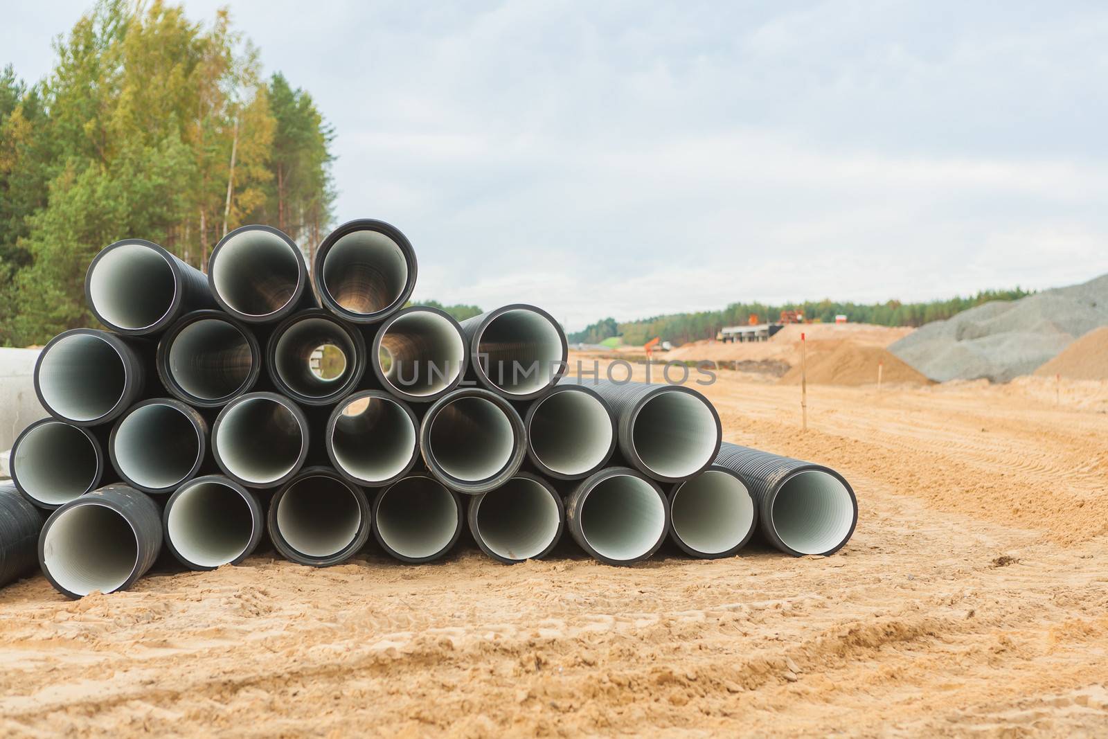 stack of big pipes on construction place