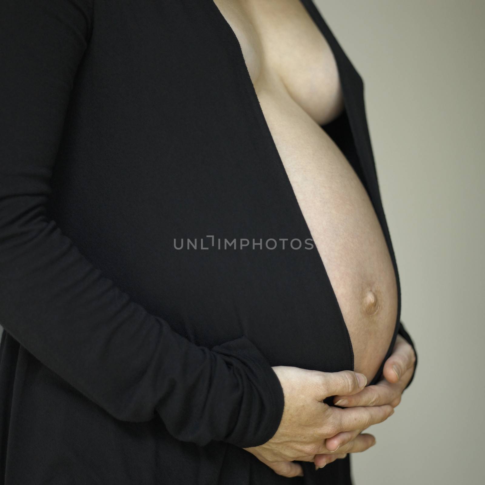 Belly of a pregant woman wearing black