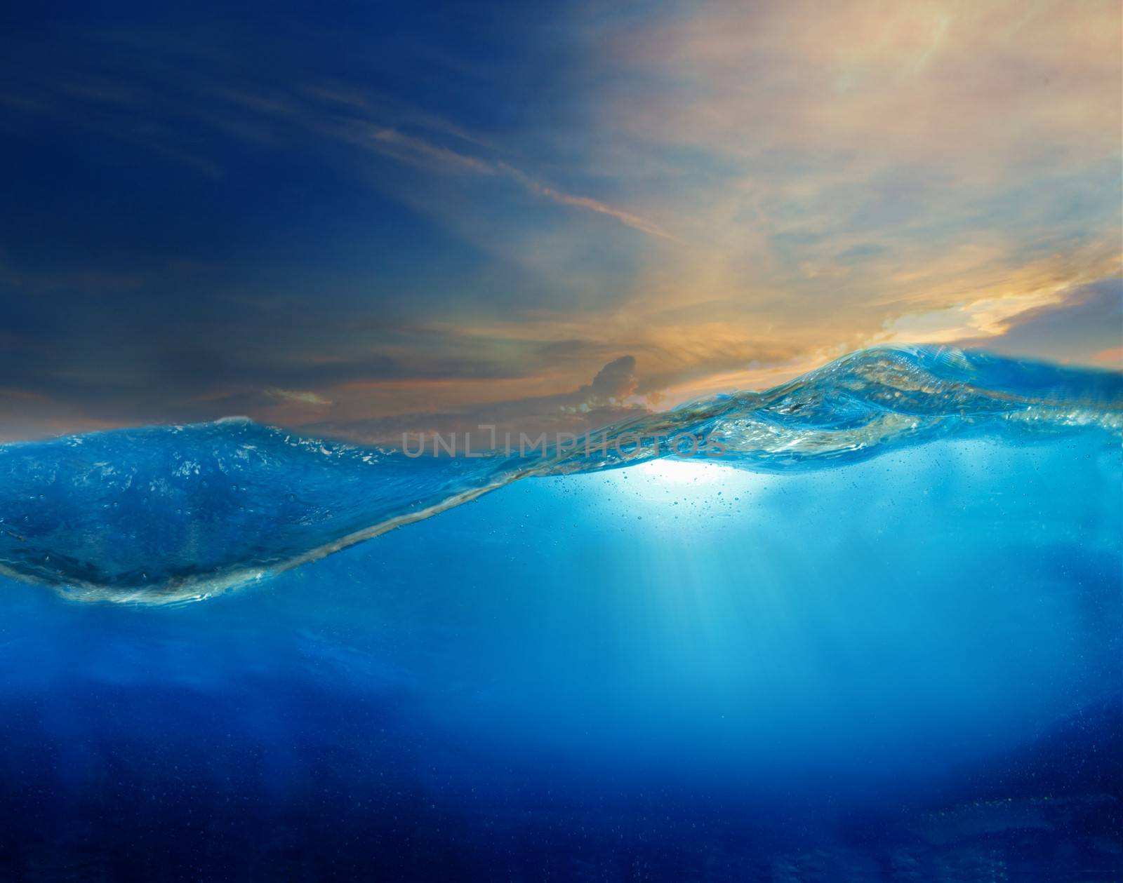 under clear water with beautiful dramatic sky above use for multipurpose natural background by khunaspix