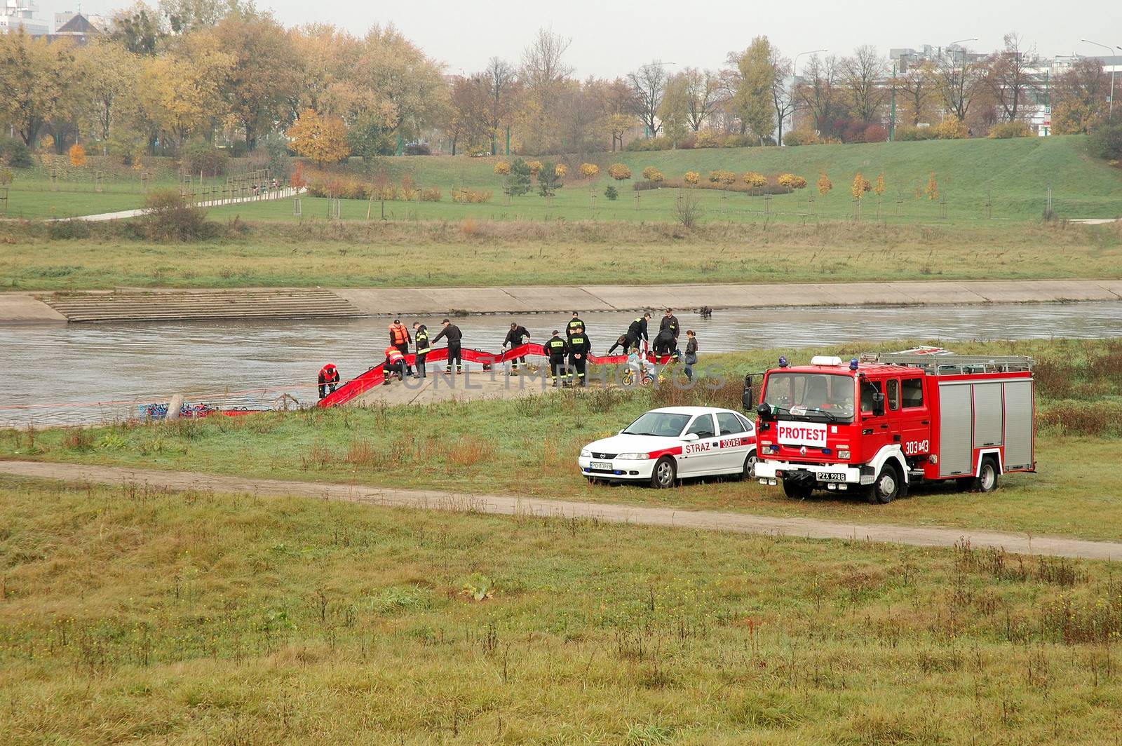 Fire brigade exercises on river bank by janhetman