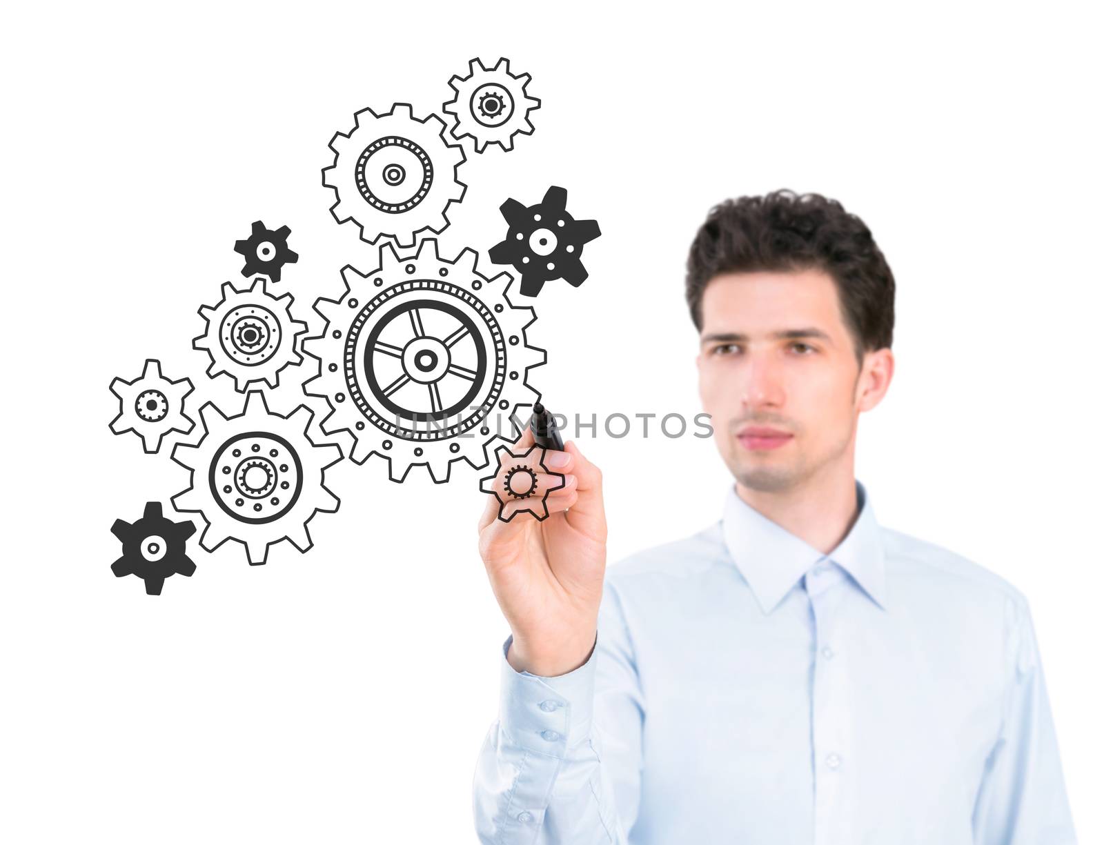 Portrait of a young pensive businessman holding a marker and drawing a concept of business development process. Isolated on white background.