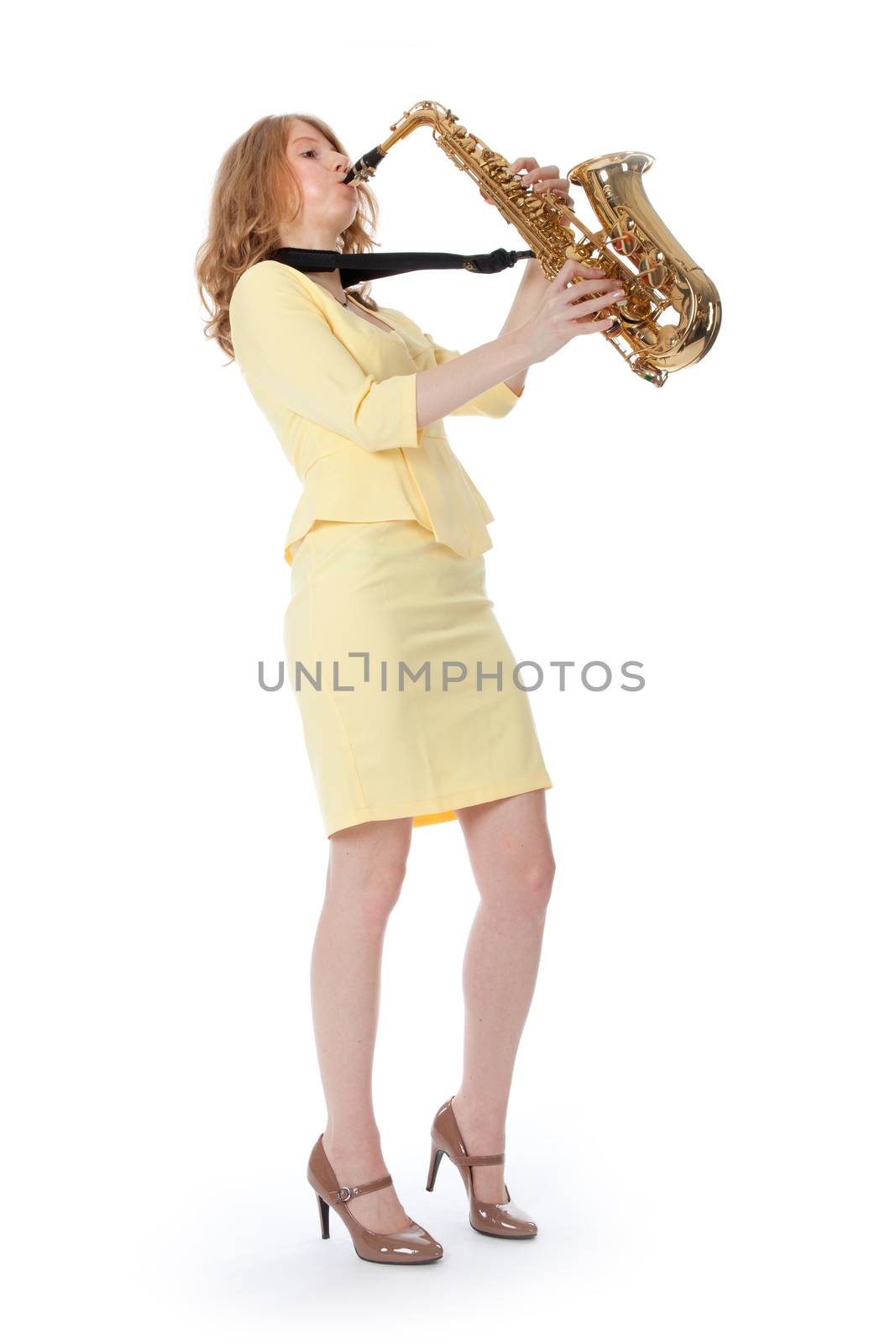 young woman in yellow mini dress playing the alto saxophone by ahavelaar