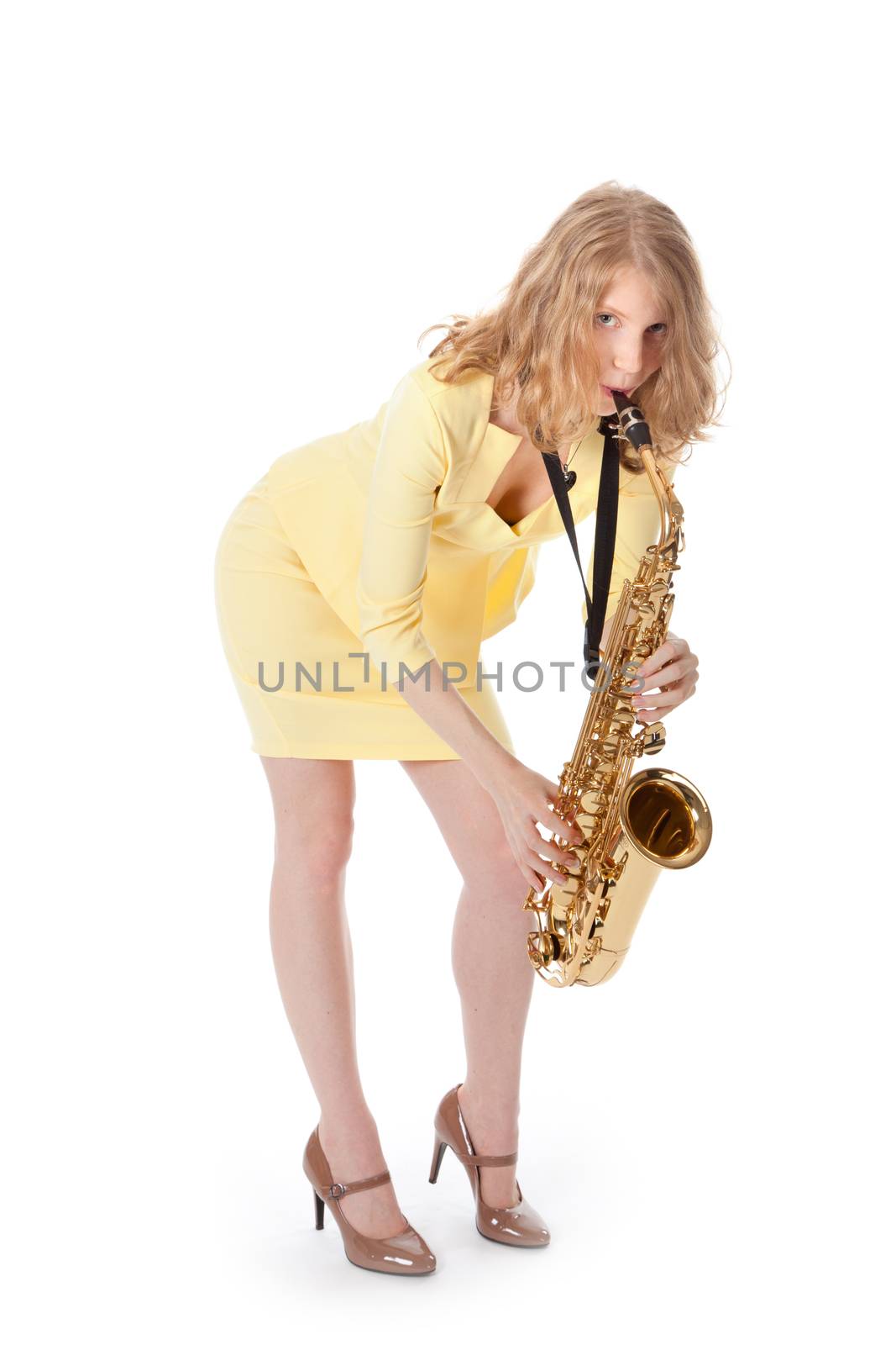 sexy young woman in yellow mini dress playing the alto saxophone by ahavelaar
