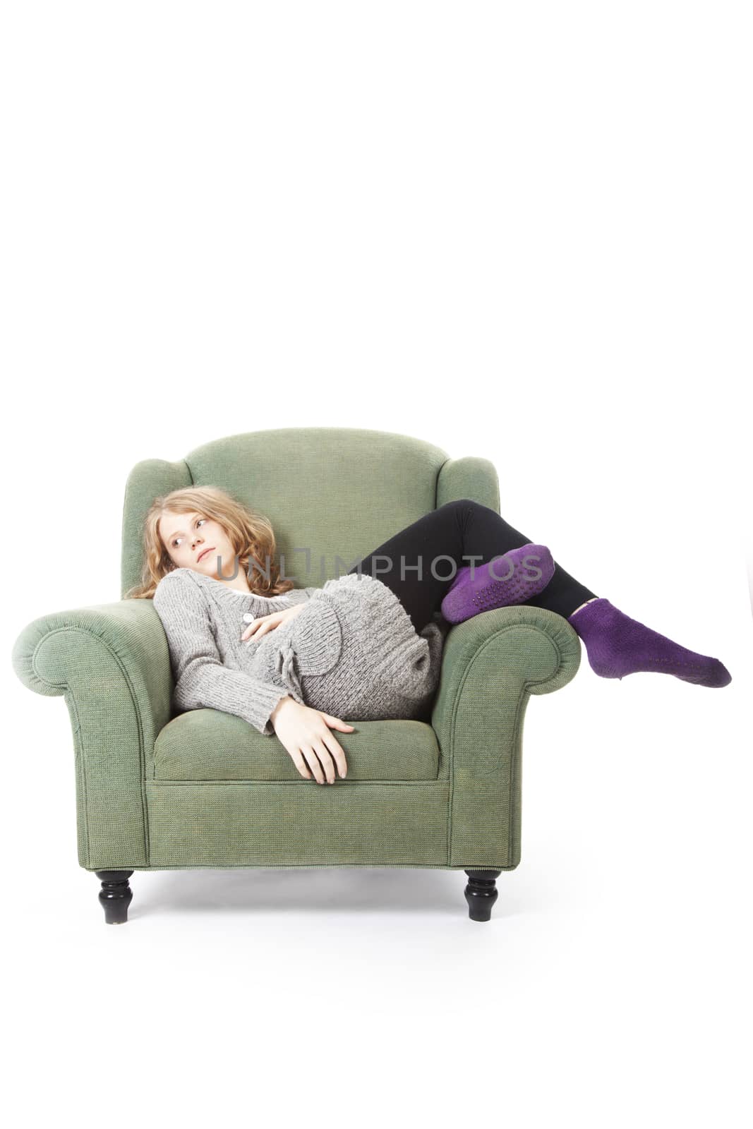 young woman relaxing in armchair against white background