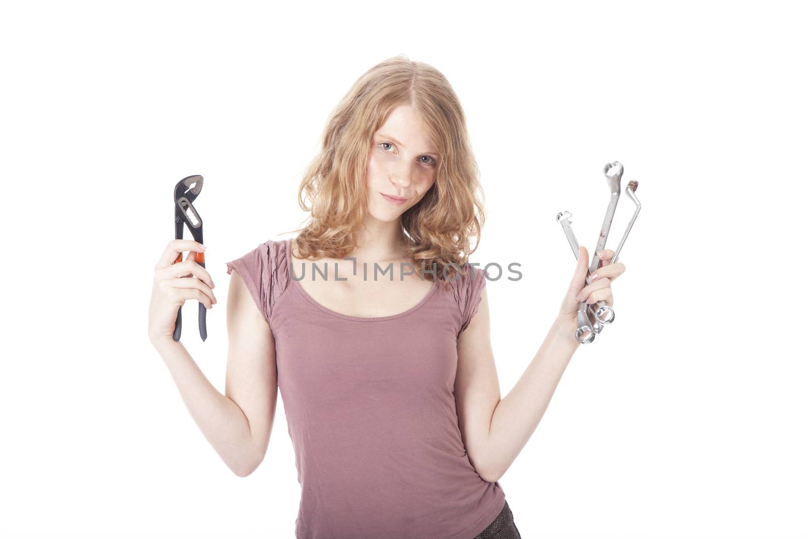 young pretty woman with ring spanners and pipe wrench by ahavelaar