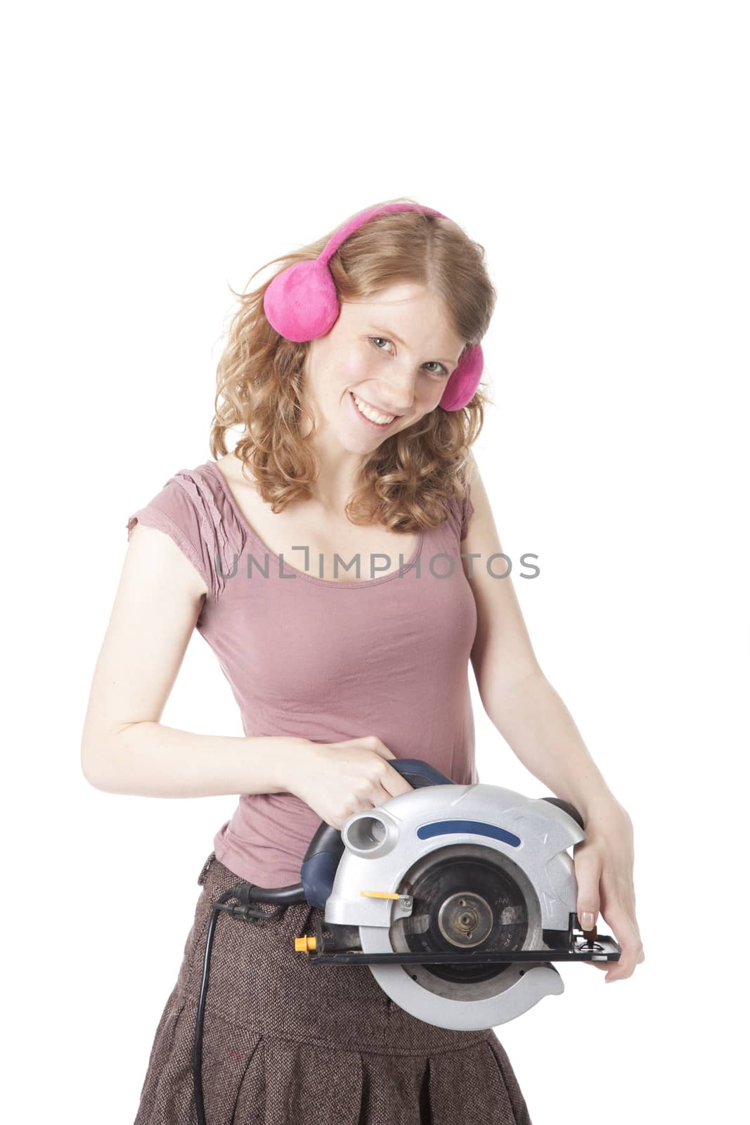 young pretty woman with circular saw against white background