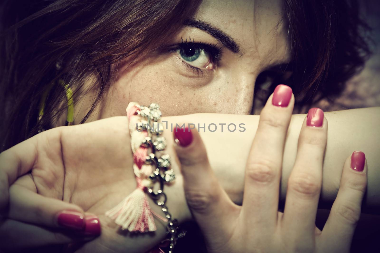 Beautiful young woman portrait with jewellery, close up, eyes focus. Fashion, beauty.