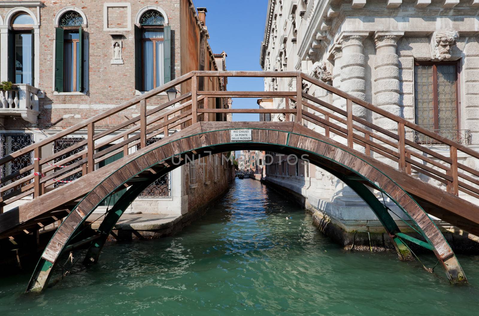 Venice, Italy. A bridge over a narrow canal among old Venetian architecture