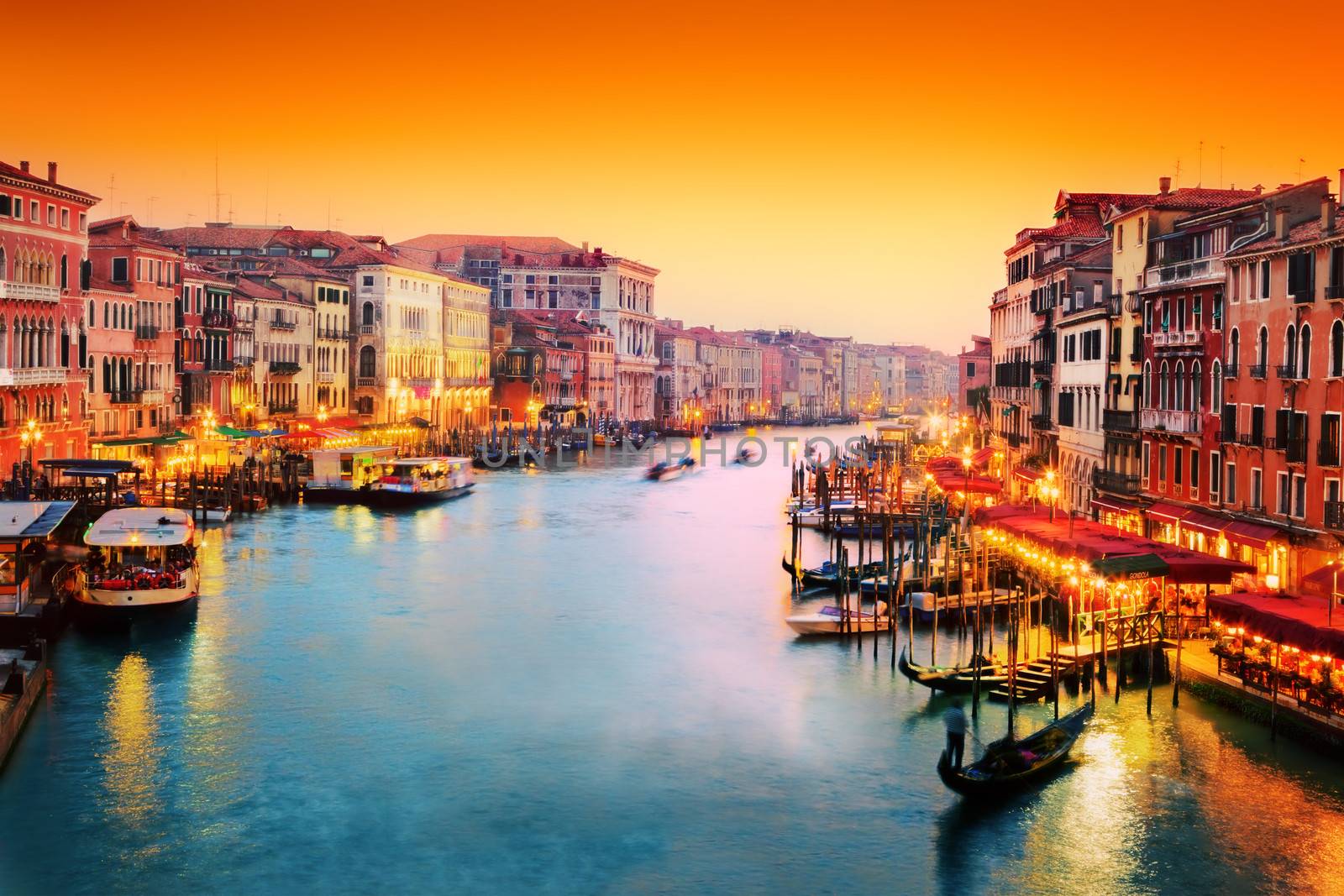 Venice, Italy. Gondola floats on Grand Canal at sunset by photocreo