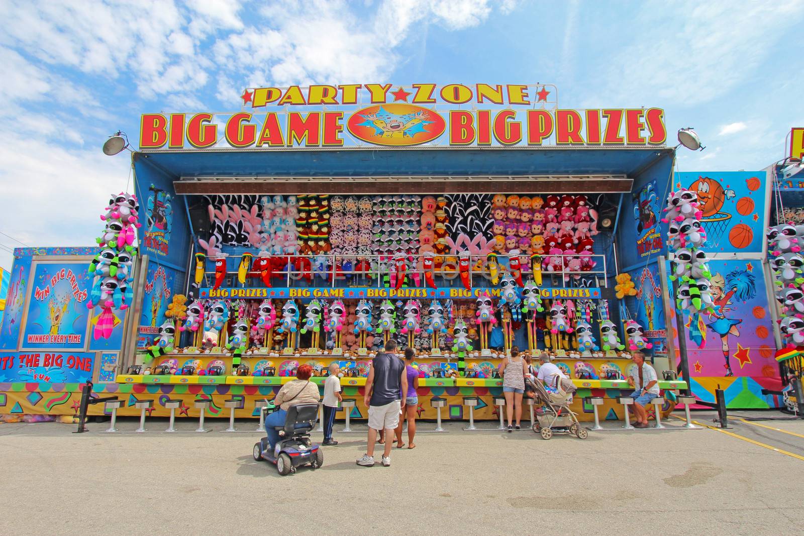 INDIANAPOLIS, INDIANA - AUGUST 12: People playing one of the games on the Midway at the Indiana State Fair on August 12, 2012. This very popular fair hosts more than 850,000 people every August.