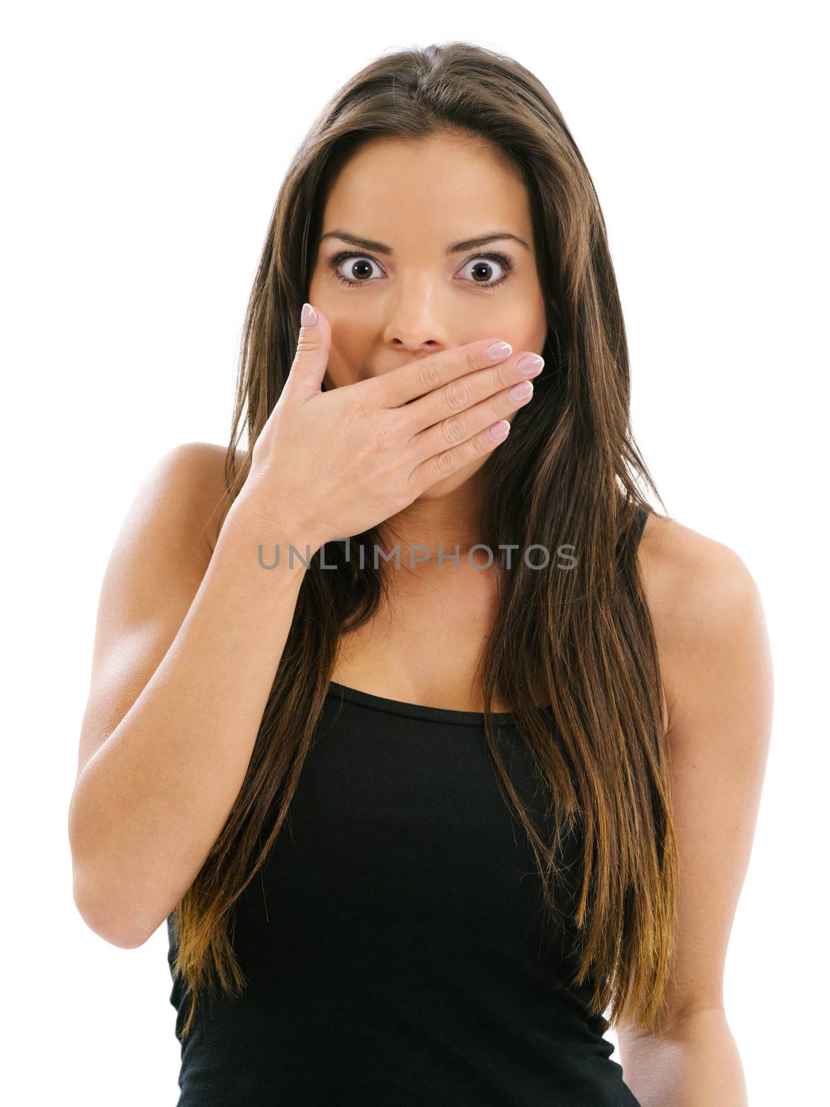 Photo of a beautiful female with her hand over her mouth and eyes wide from shock.