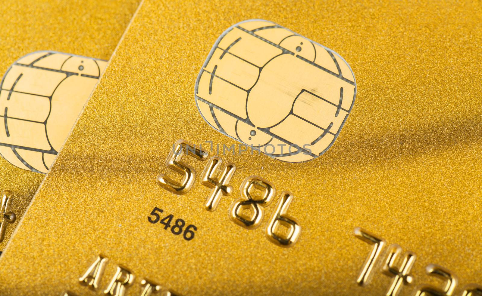 Macro view of golden credit cards with microchips