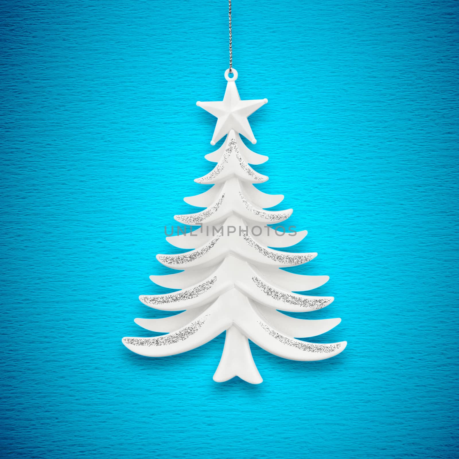 Christmas tree on a background of blue paper