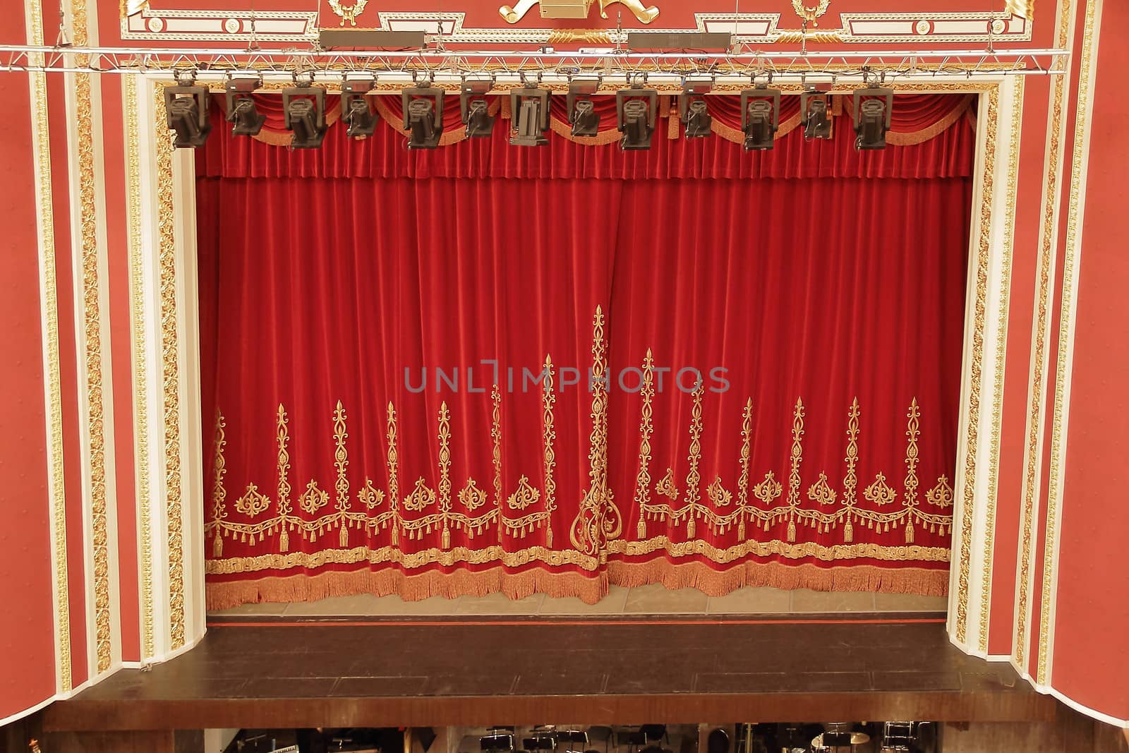 Theatrical red velvet curtain with gold pattern