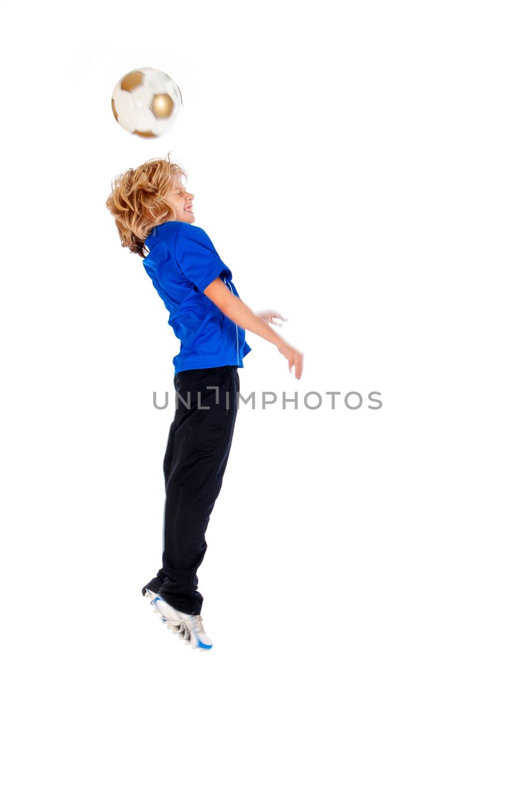 Portrait of a young soccer player heading ball isolated over white background