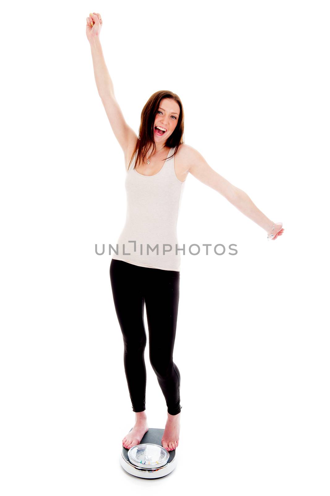 a girl on a weighing scale, celebrating her success of loosing weight