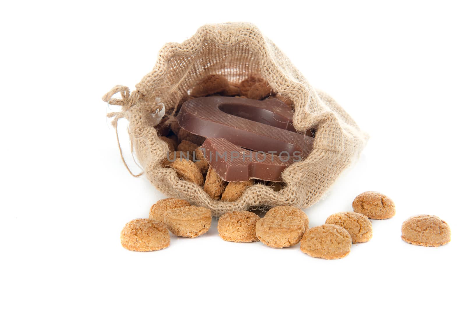 A jute bag full of pepernoten and a chocolate letter, for celebrating a dutch holiday " Sinterklaas "  on the fifth of December