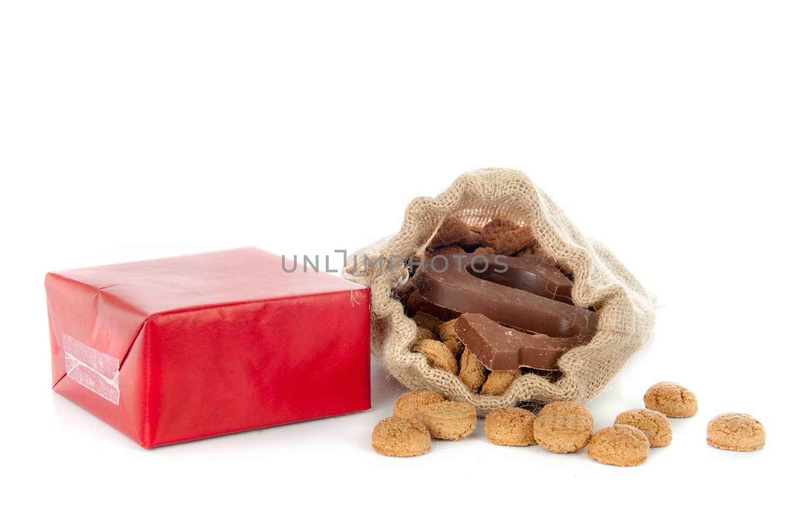 A jute bag full of pepernoten and a chocolate letter, for celebrating a dutch holiday " Sinterklaas "  on the fifth of December