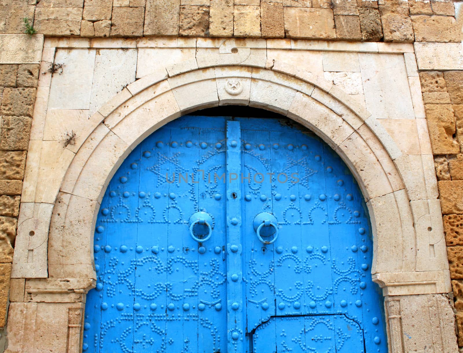 Blue gate in the stone wall