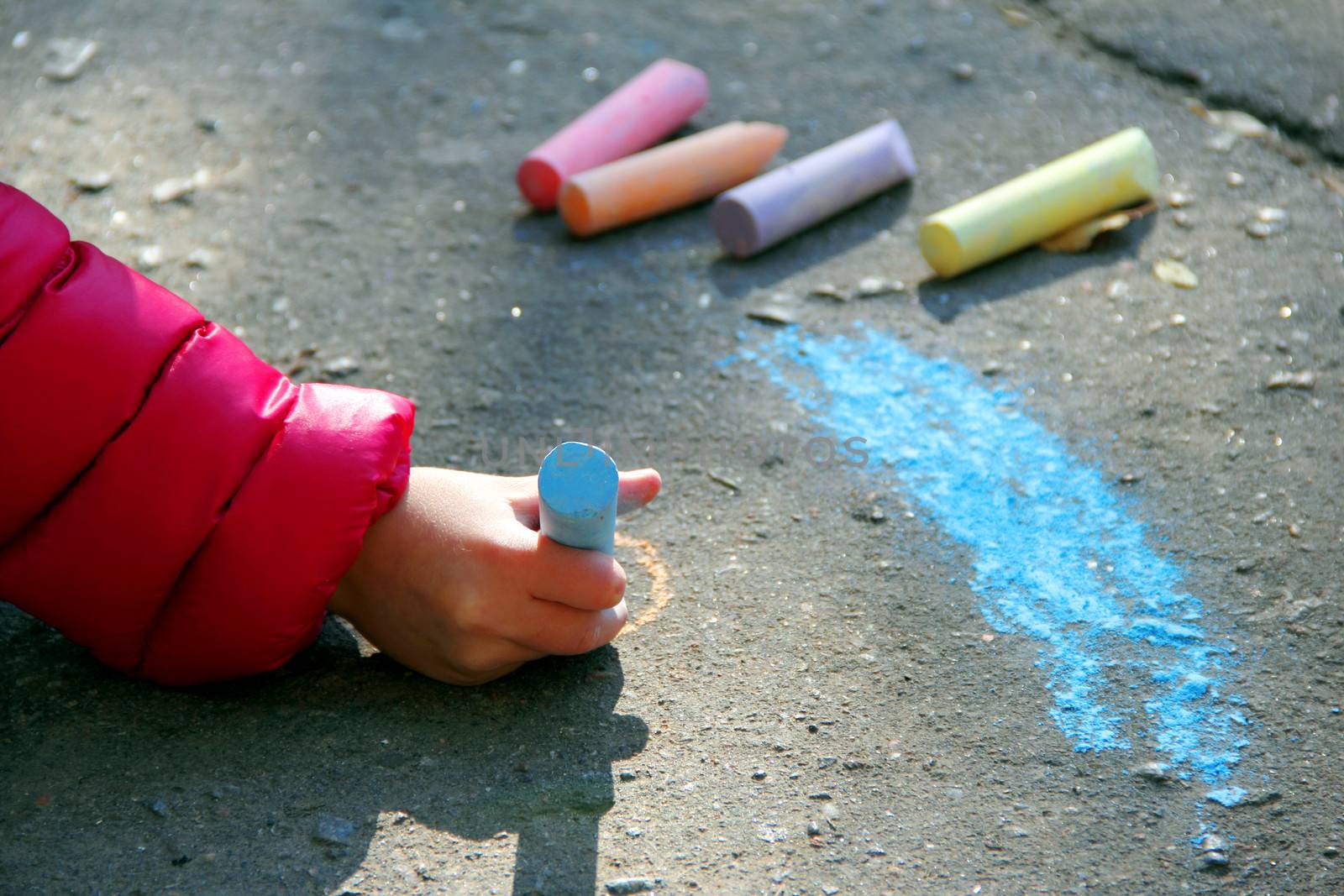 hand with  chalk draw on  asphalt