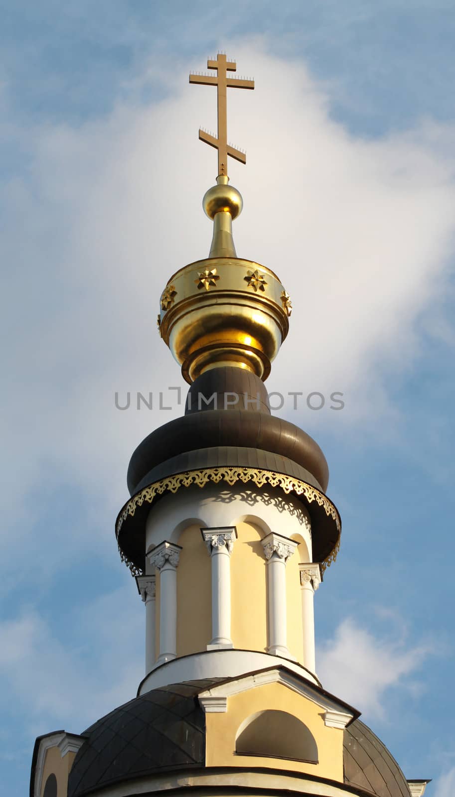 The golden dome of the church with the cross