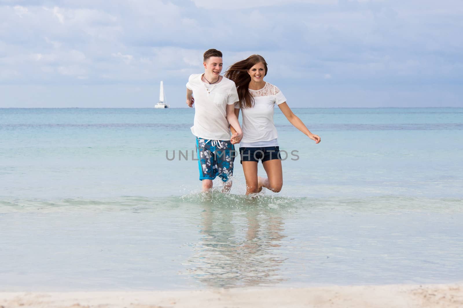 young happy couple in summer holiday vacation summertime beach