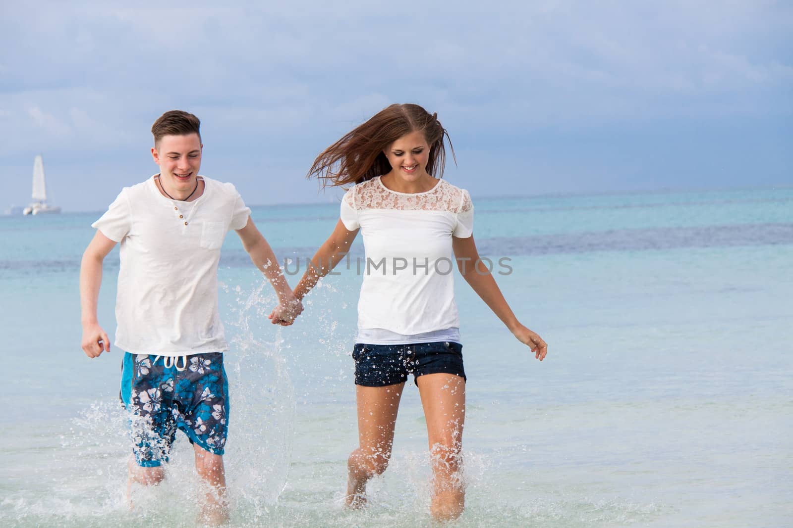 young happy couple in summer holiday vacation summertime beach