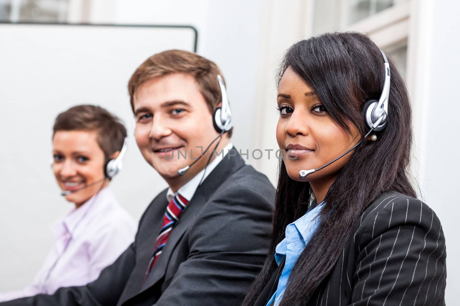 smiling callcenter agent with headset support by juniart