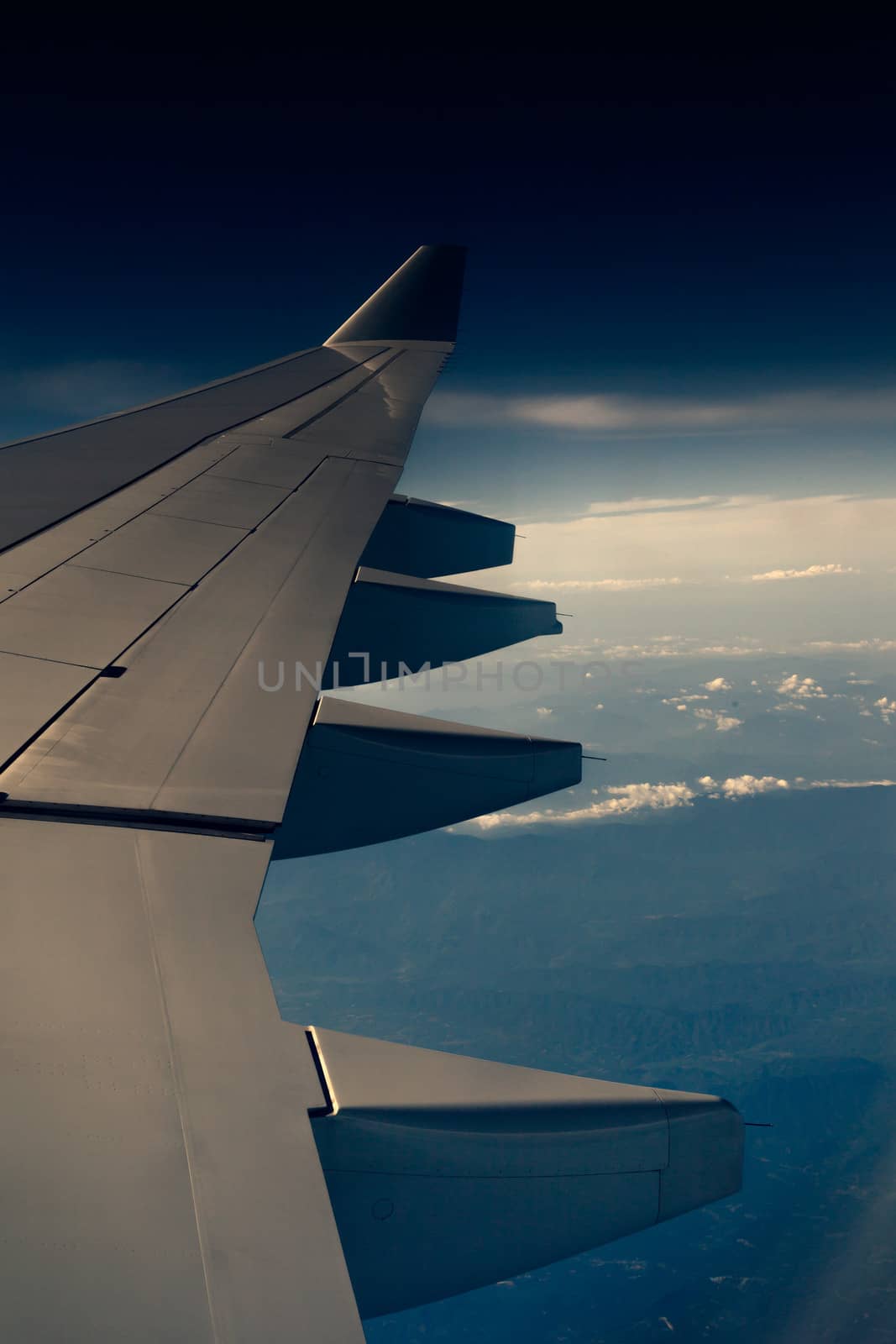 Wing of an airplane and cloud in background