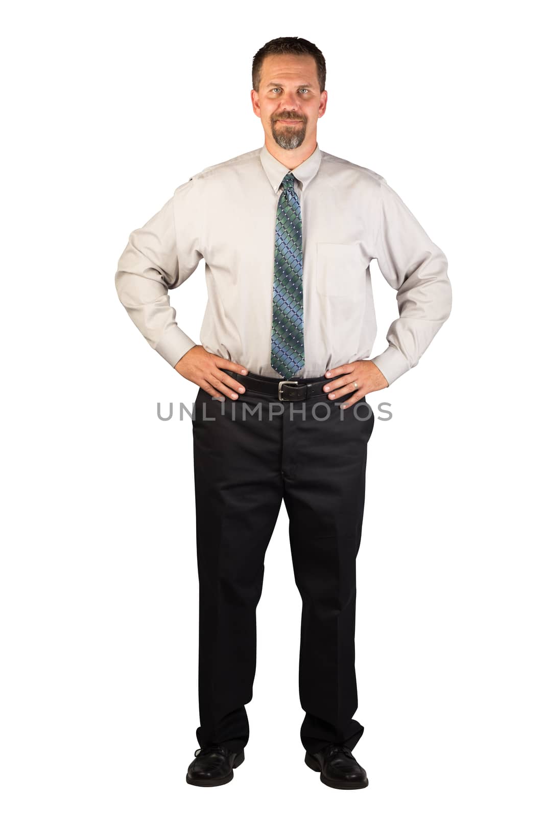 A white collar worker standing facing the viewer with hands firmly on hips. This man could be a spokesperson for a business. This man could be a corporate person that could deal with insurance, finance, real estate, stock market, restaurant industry, home improvement industry or other industries.
