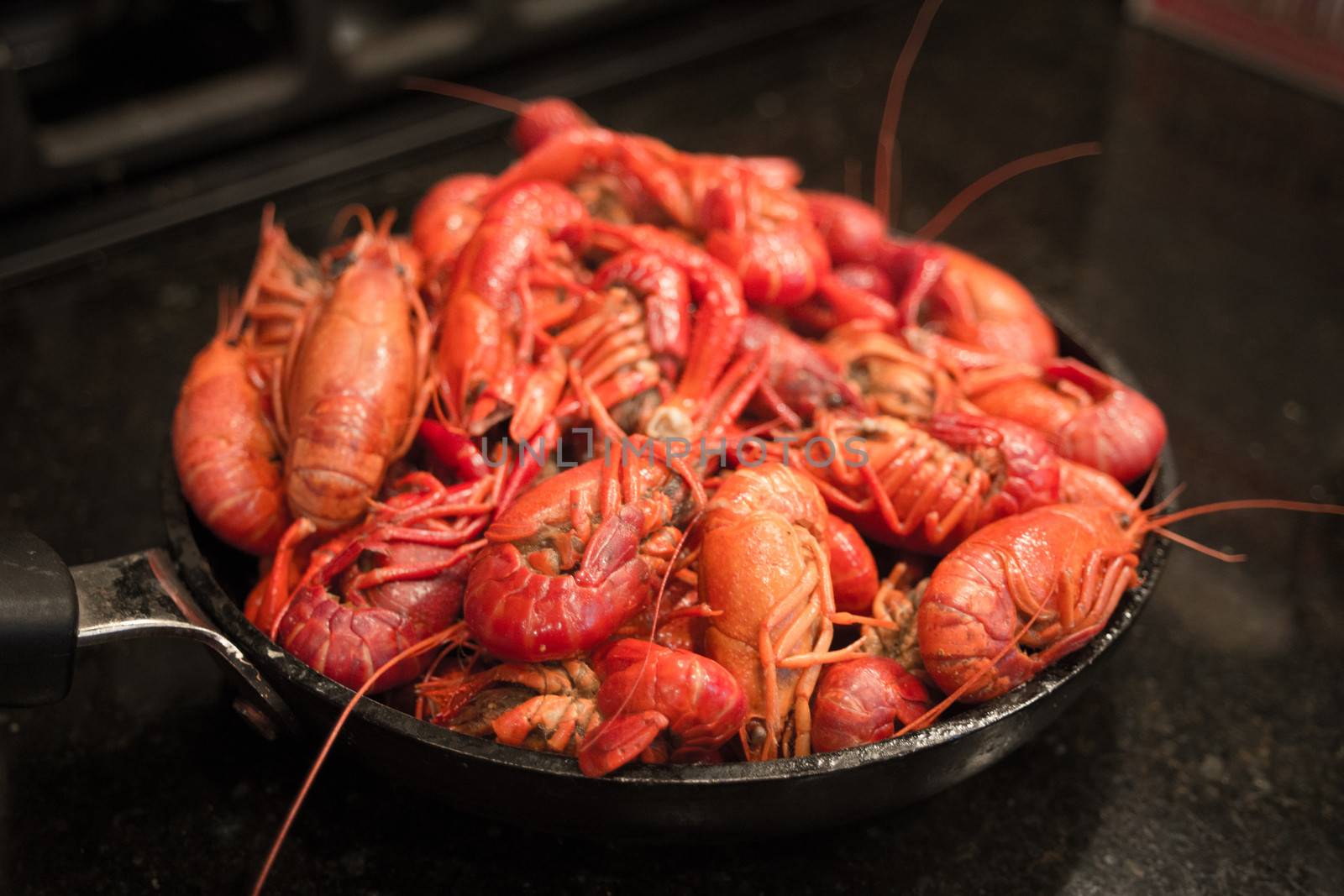 A beautiful red skillet full of crawfish, freshly steamed and ready to eat.