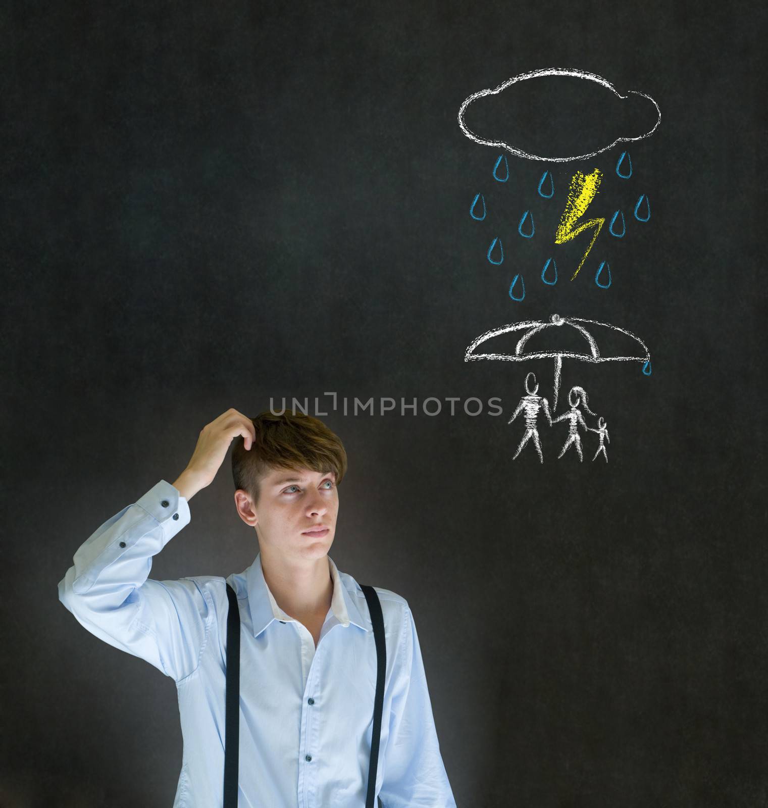 Insurance businessman thinking about protecting family from natural disaster on blackboard background