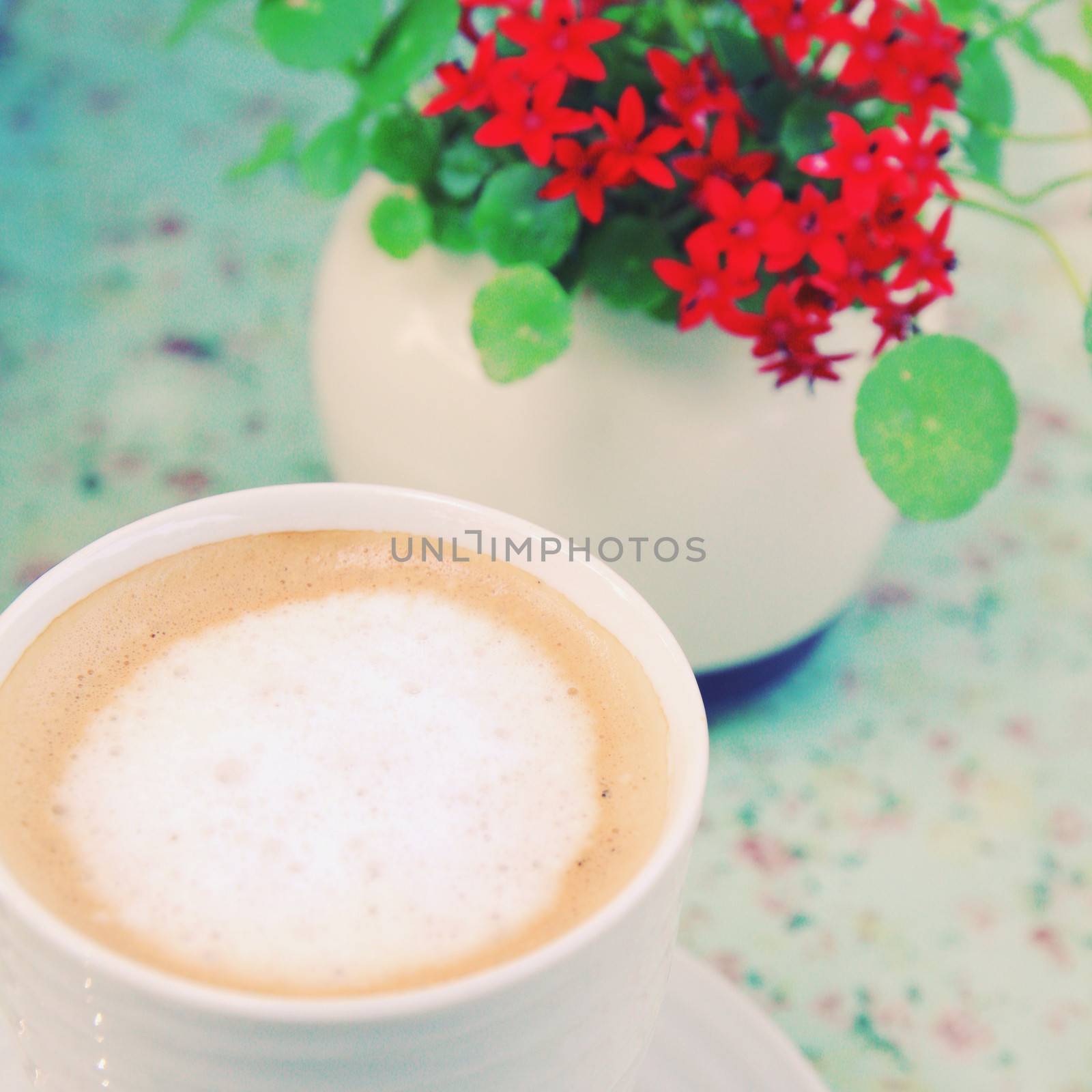 Cup of cappuccino coffee and flower with retro filter effect by nuchylee